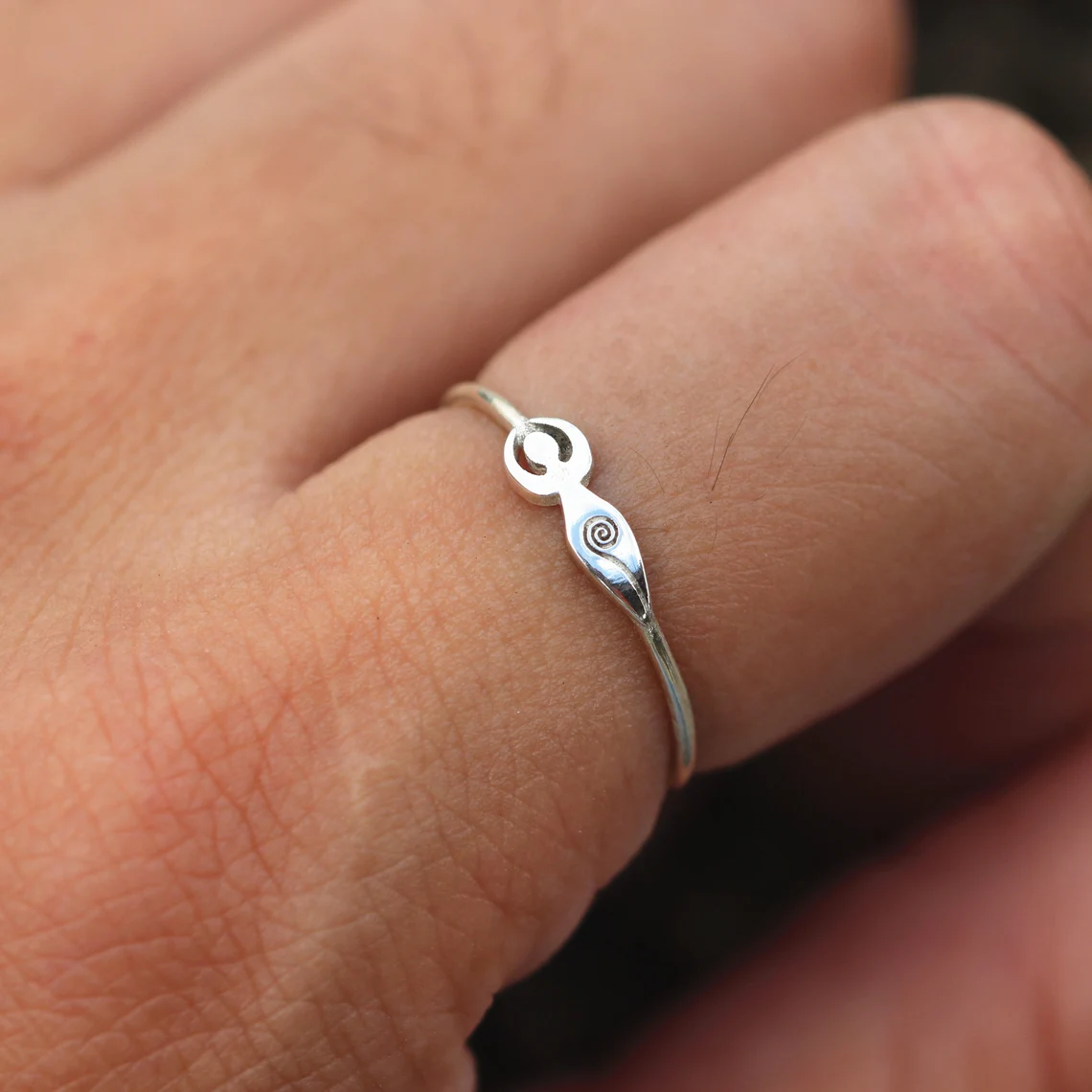 silver spiral goddess ring on the finger