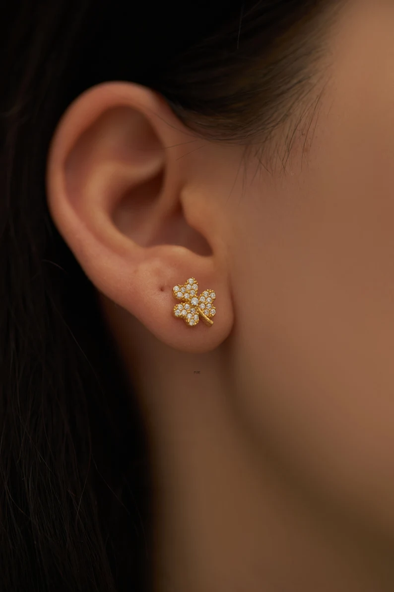 shamrock stud earrings on the ear
