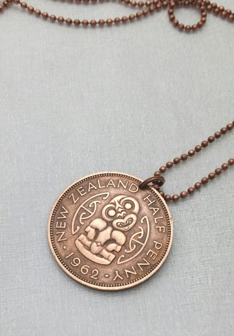 Copper coin featuring Hei-Tiki