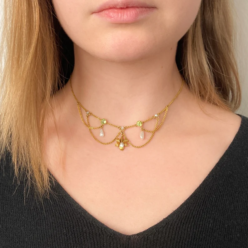 antique festoon necklace on the woman's neck