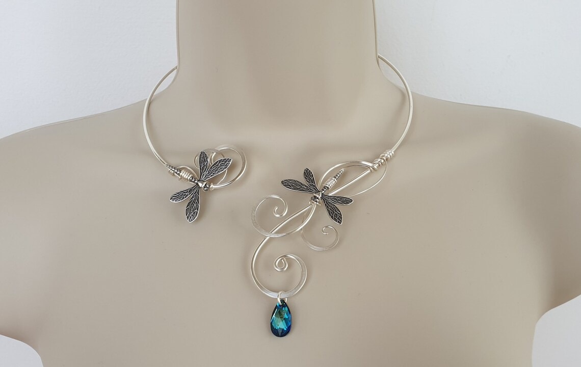 silver dragonfly torque necklace with blue crystal