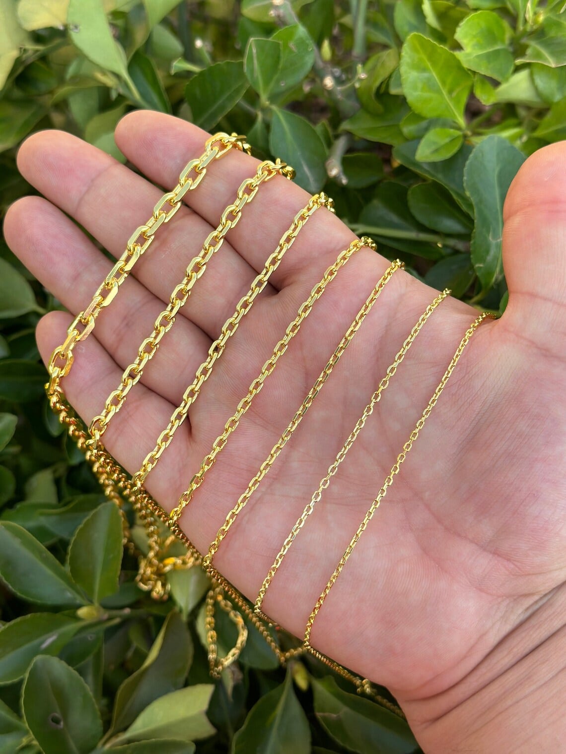 gold plated anchor chains on the hand