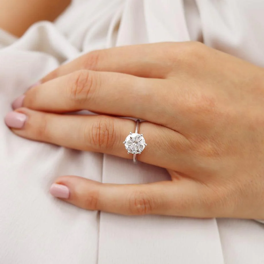 round moissanite ring on the ring finger