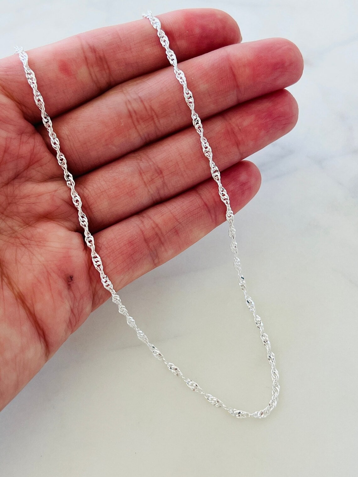 sterling silver singapore chain necklace on the hand