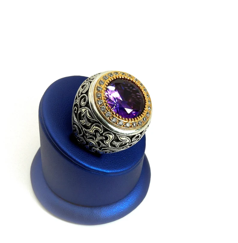 amethyst bishop ring on a blue ring stand