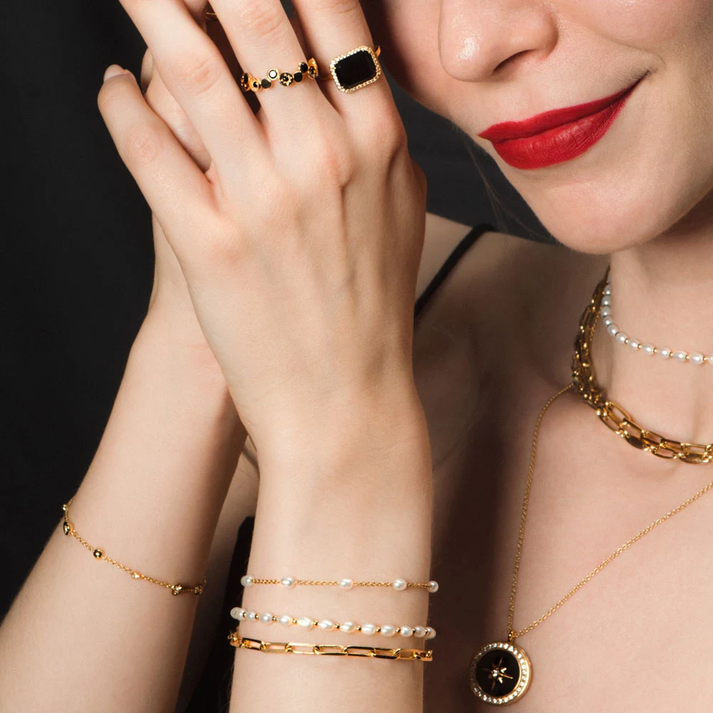 a woman wearing atley clark gold jewelry
