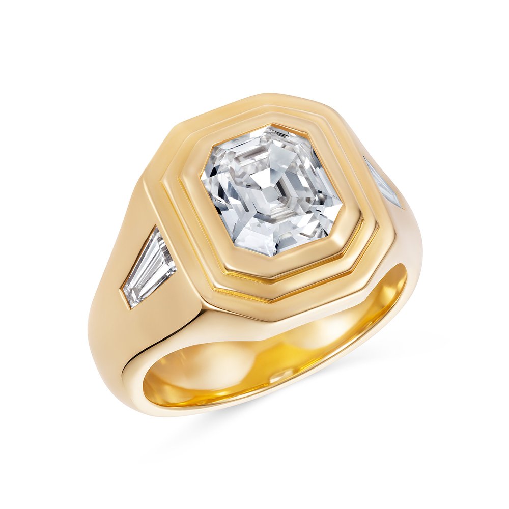 three stone diamond engagement ring in yellow gold setting