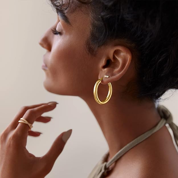 gold plated chunky hoop earring on the woman's ear
