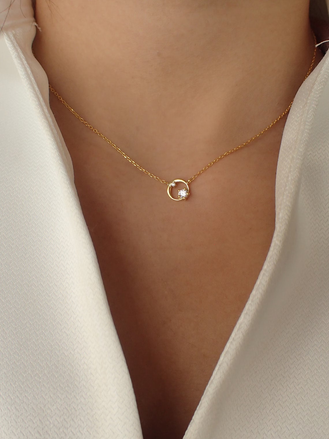 gold plated cz circle necklace on the neck