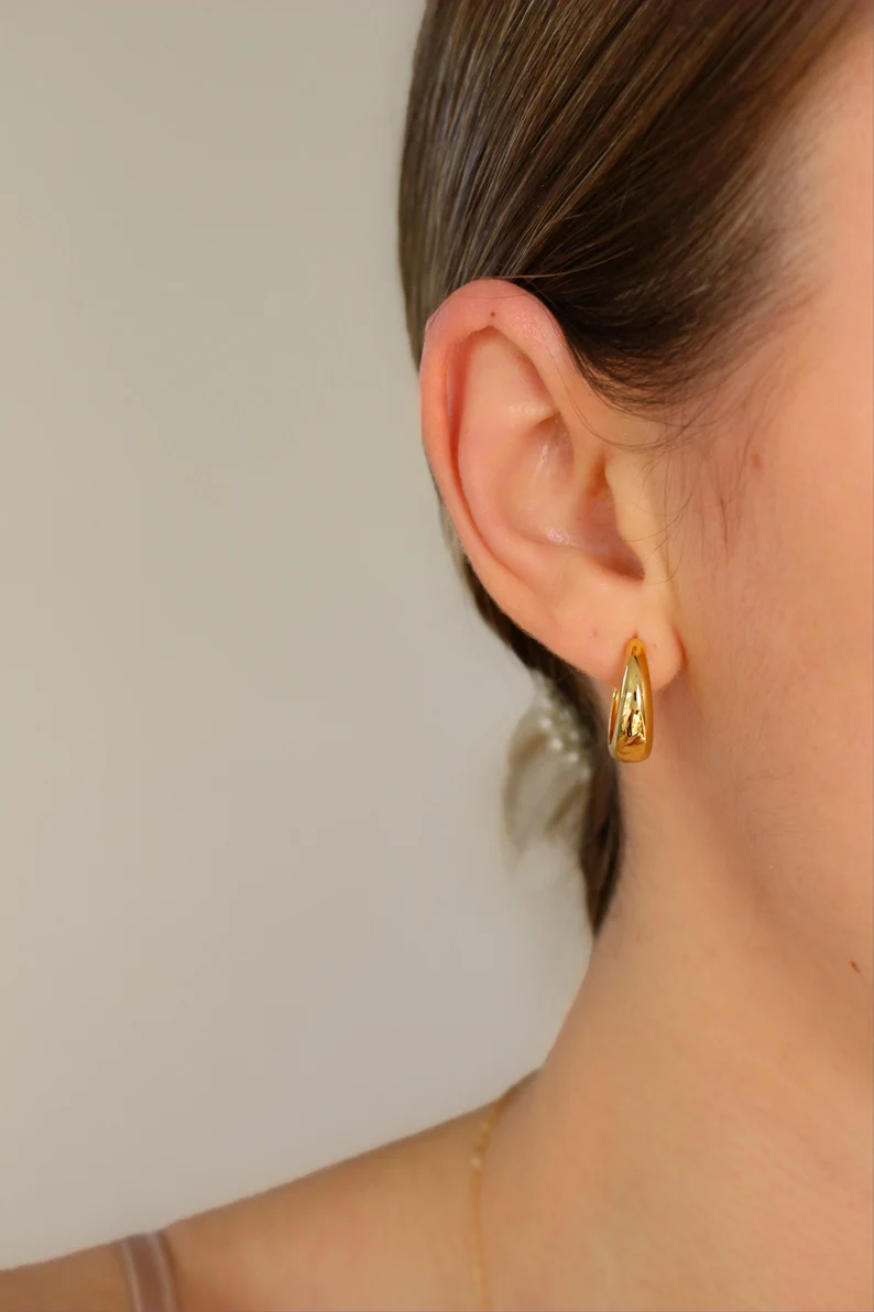 gold vermeil hoops earring on the woman's ear