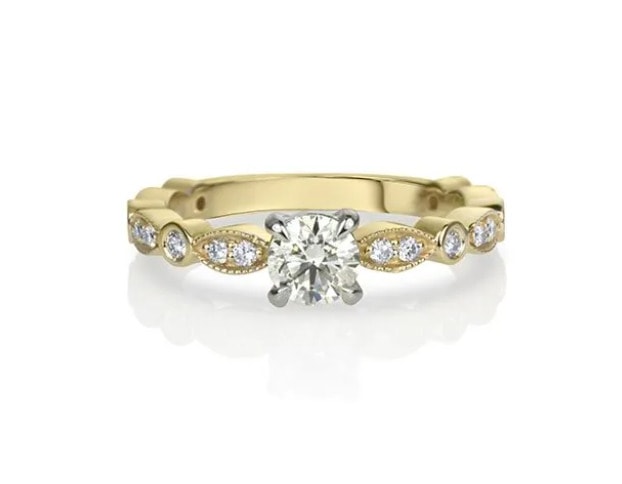 round cut diamond with marquise side stones engagement ring