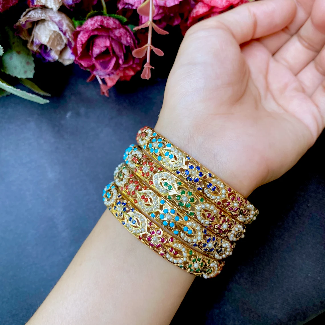 colorful gemstone mughal bangles on the wrist