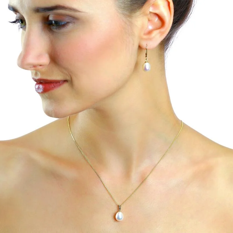 a woman wearing pearl pendant necklace and earrings