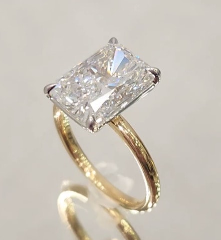 emerald cut diamond engagement ring in yellow gold setting