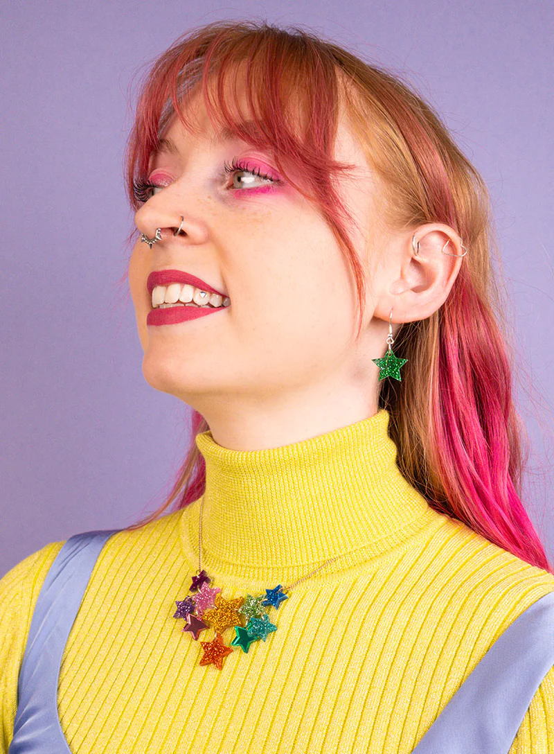 a woman wearing tatty devine necklace and earrings