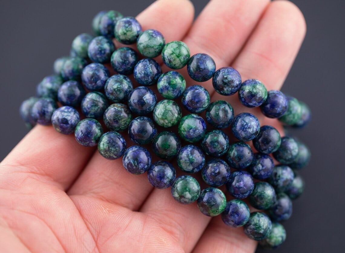 a hand with azurite beaded bracelet
