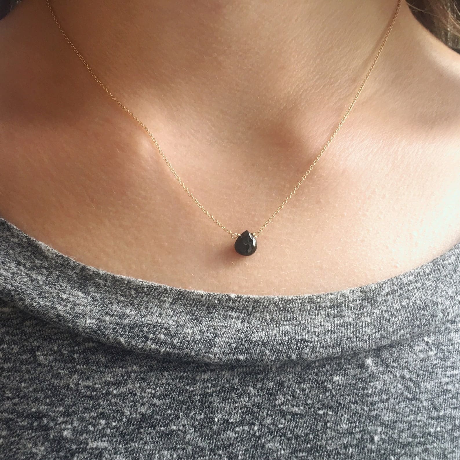 black spinel pendant necklace on the neck