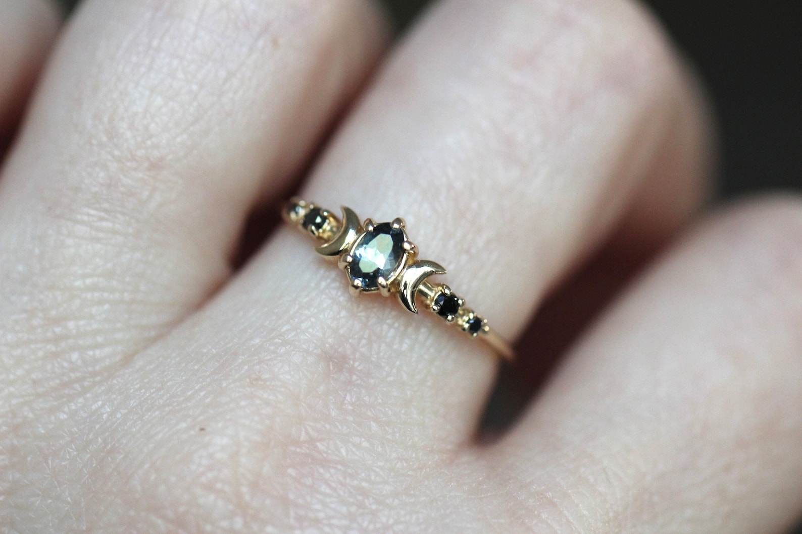 moon phase spinel ring on the finger